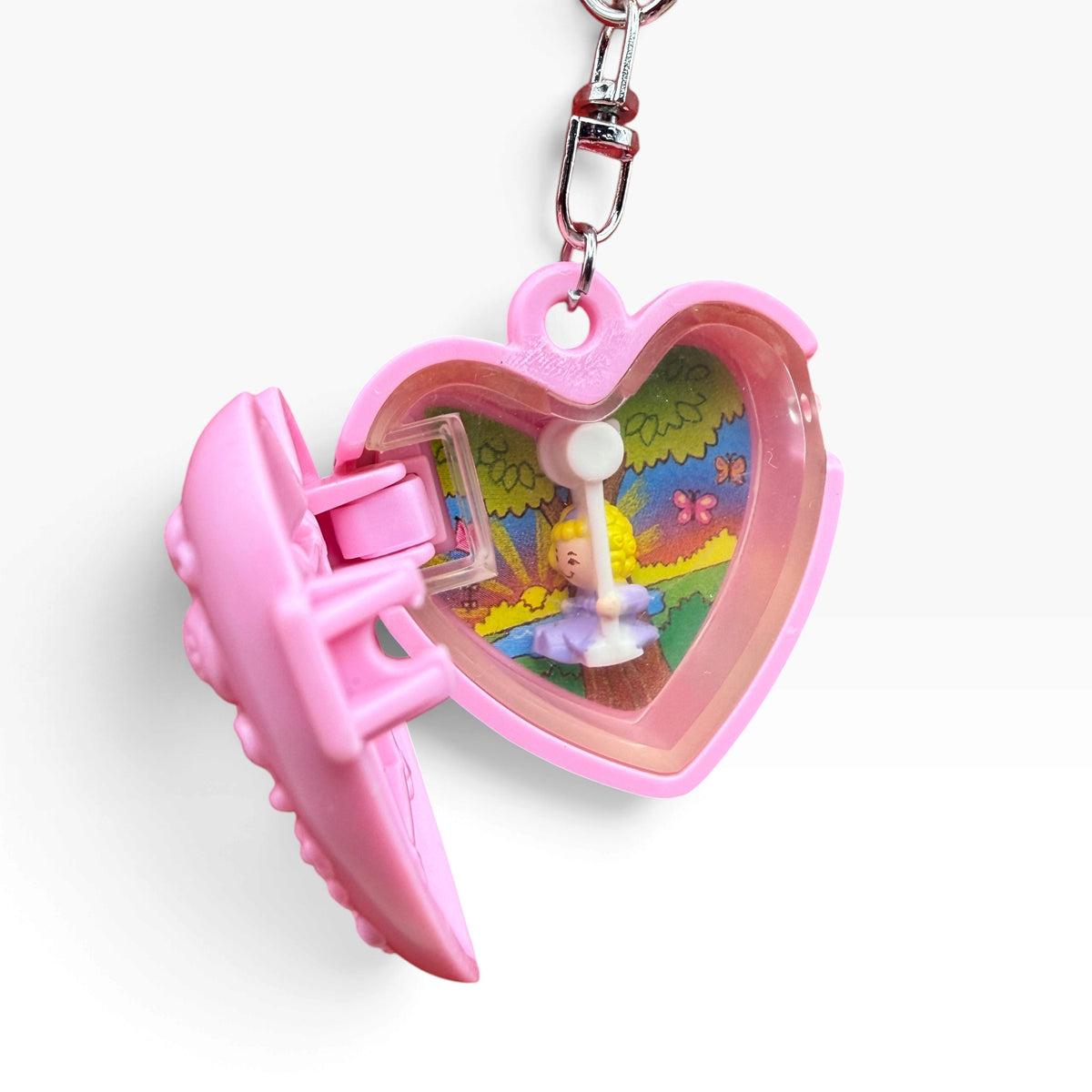 Open 1994 Polly Pocket pink heart compact showing the miniature interior before final embellishment