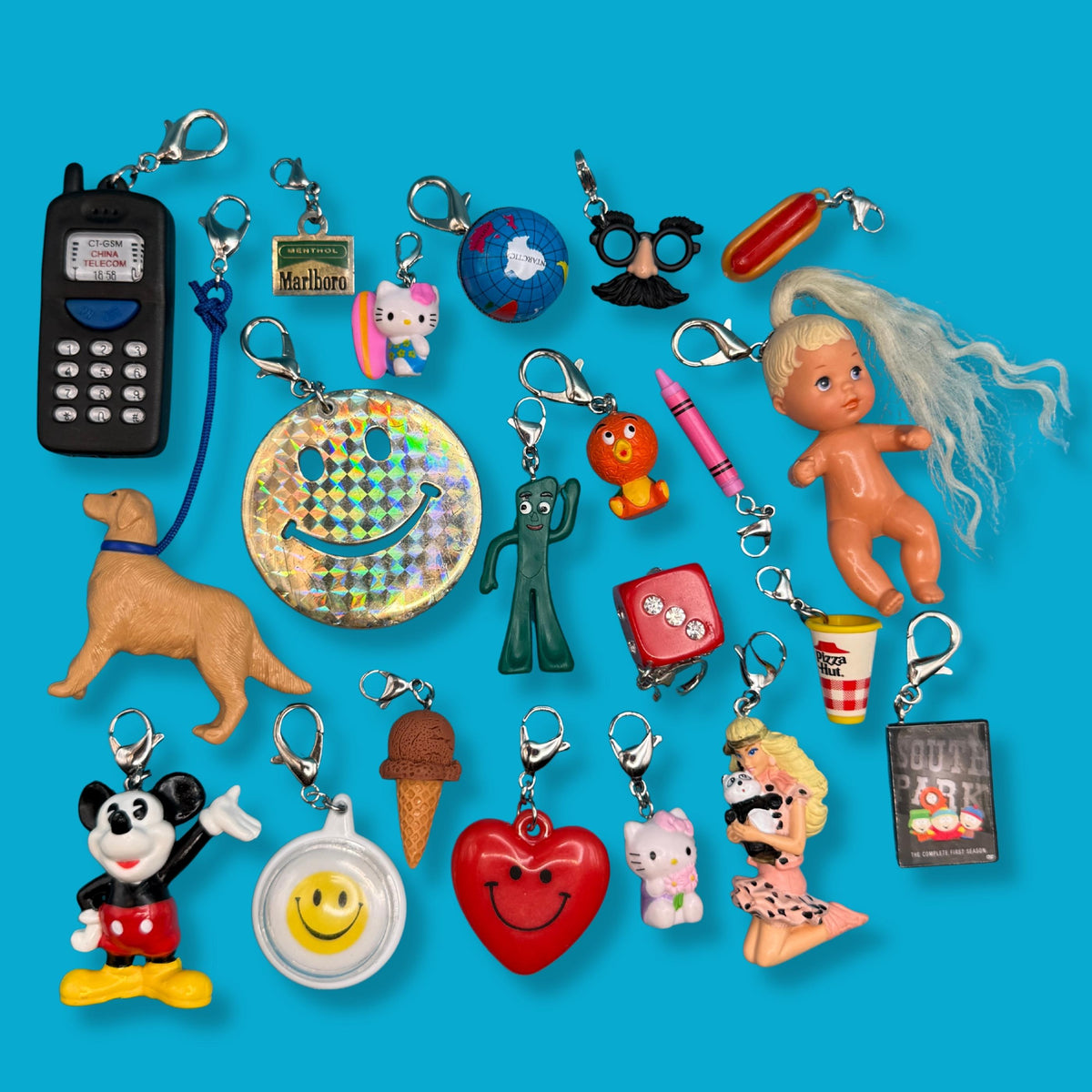 Vintage mini trinket bag charm collection with Barbie, Hello Kitty, Gumby, South Park, and novelty charms