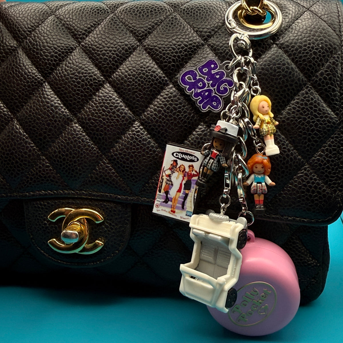 Clueless Polly Pocket Bag Charm Keychain and Pink Polly Pocket Compact Charm photographed on a Chanel classic medium double flap bag
