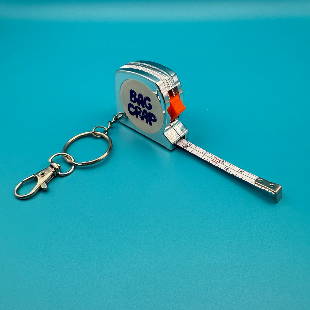 BAG CRAP Silver Plastic Measuring Tape Keychain