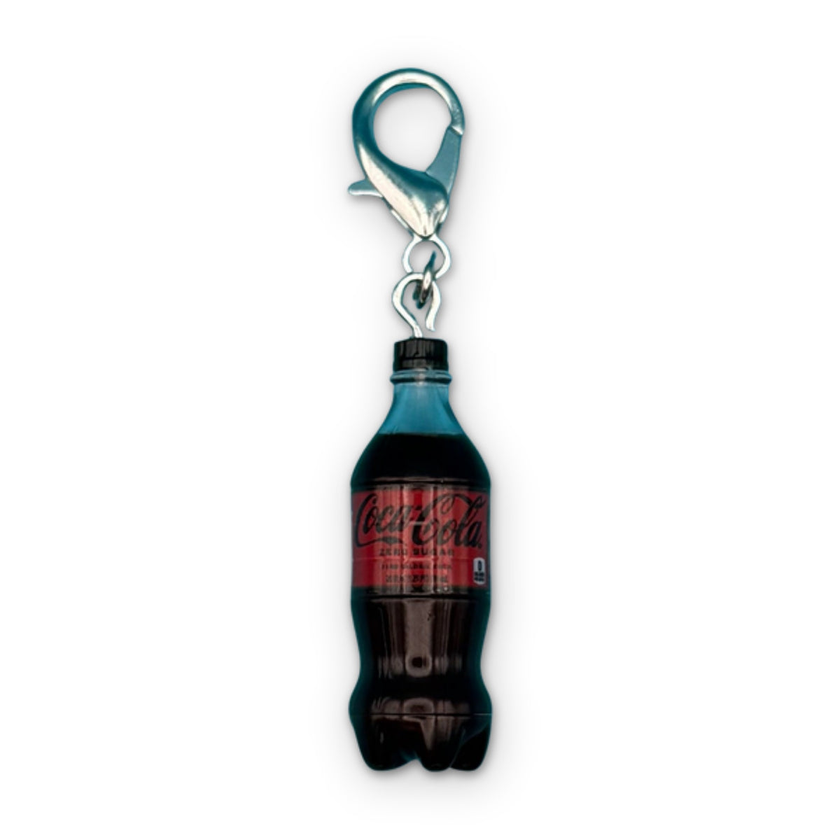 Mini Coke Zero Sugar Soda Bottle Bag Charm on a white background