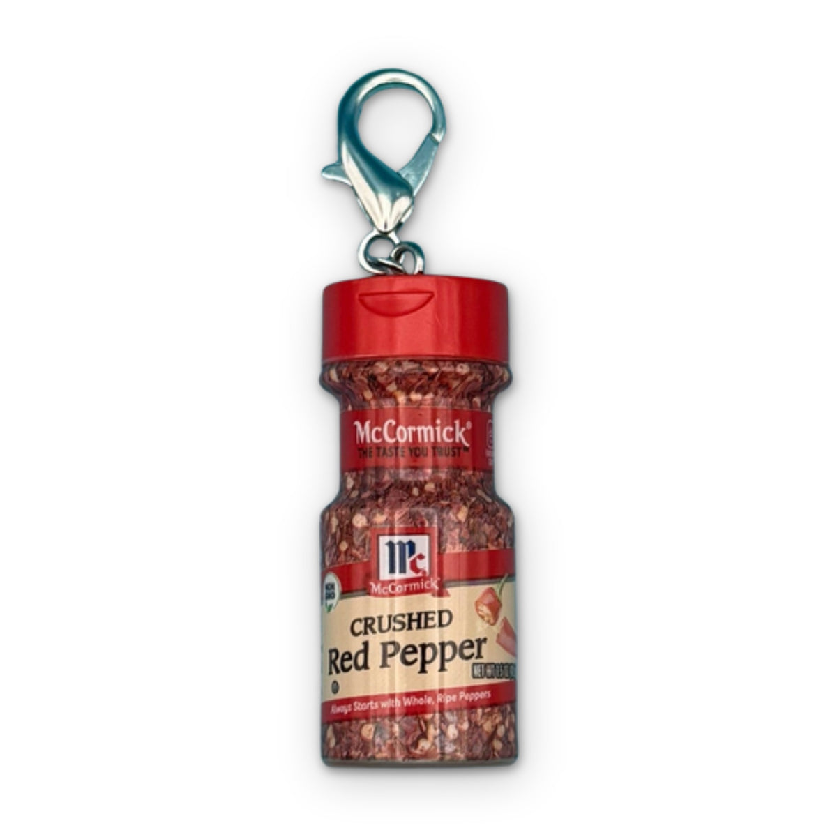 Mini McCormick Crushed Red Pepper Bag Charm on a white background
