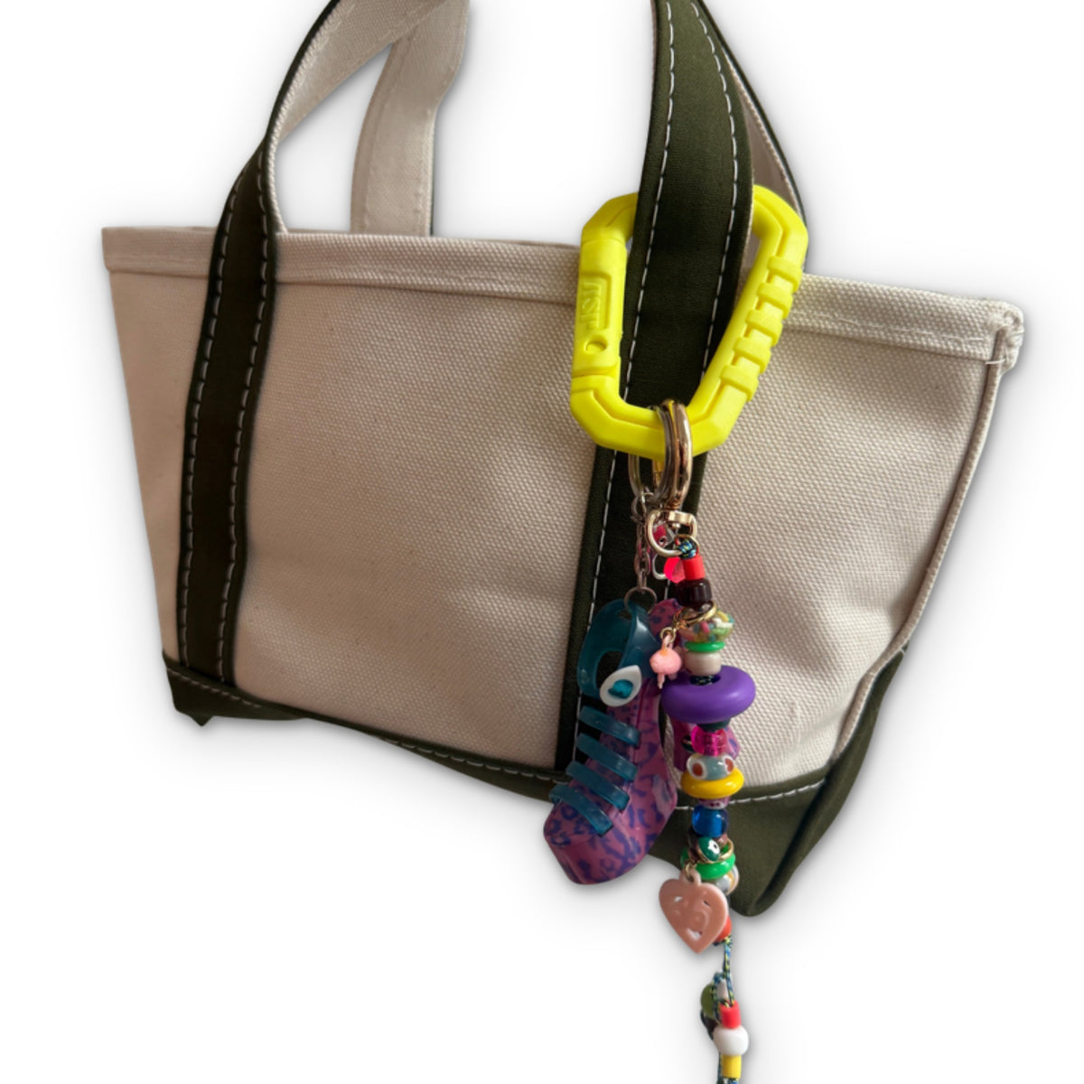 Neon Yellow Thick Plastic Carabiner Clip styled on a bag, on a white background