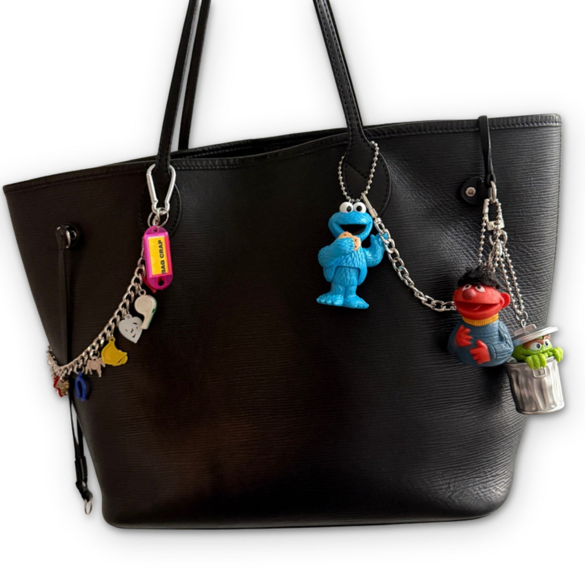 Vintage Sesame Street Toy Bag Charms styled on a bag, on a white background
