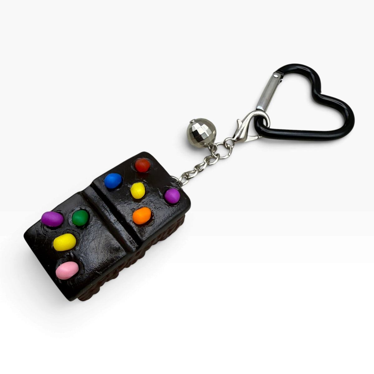 Nostalgic Cosmic Brownie and silver disco ball bag charm with black heart carabiner on white